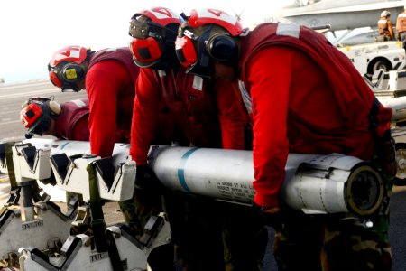 Sailors move ordnance at sea. (8413079189)