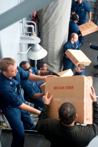 Sailors move supplies at sea. (8283345381)