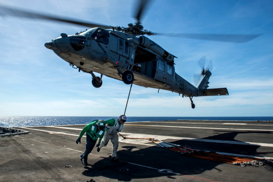Sailors get clear as a helicopter lifts off.-N-HD510-112 (16634276014)