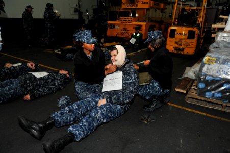 Sailors help a simulated victim at sea. (8488249507)