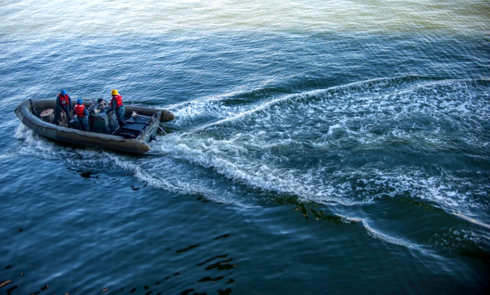 Sailors operate a rigid-hull inflatable boat 141006-N-LI192-087