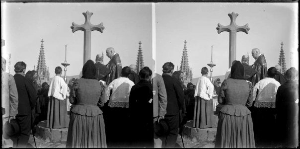 Sacerdots i gent al voltant d'una creu al terrat de la catedral en la benedicció del terme de Barcelona