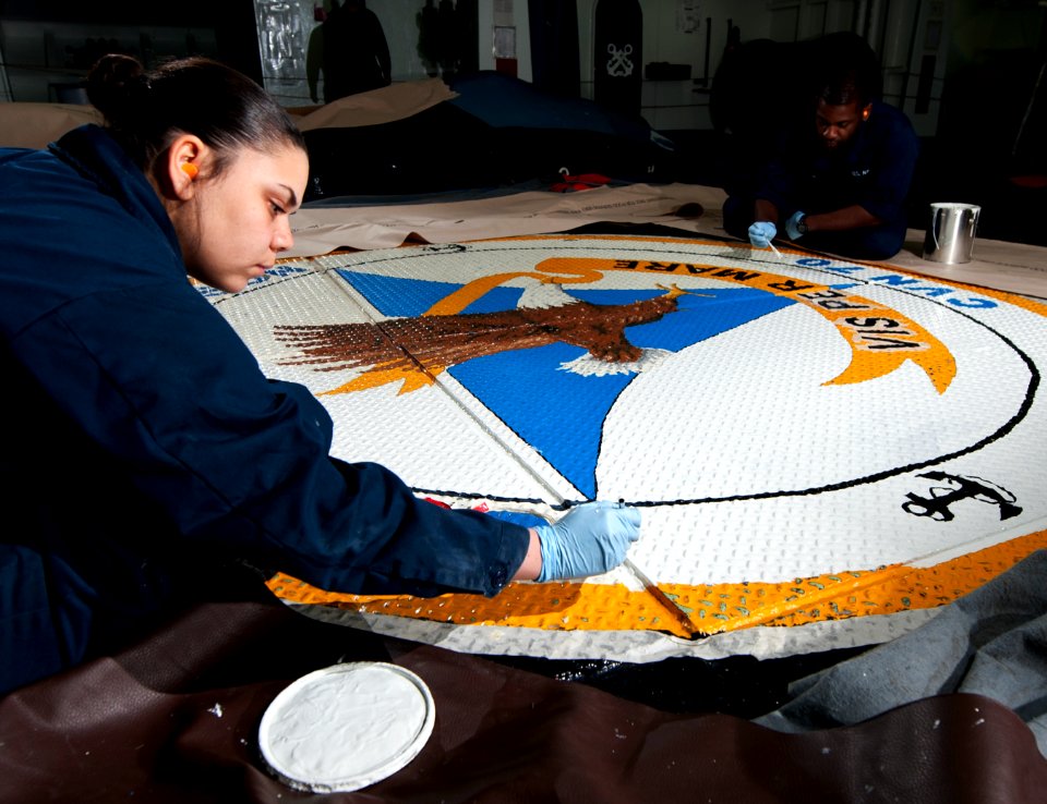 Sailors paint the ship's crest aboard USS Carl Vinson. (8488251061)