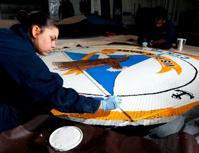 Sailors paint the ship's crest aboard USS Carl Vinson. (8488251061)