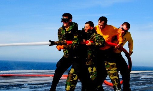 Sailors participate in a flight deck washdown. (8448065632)