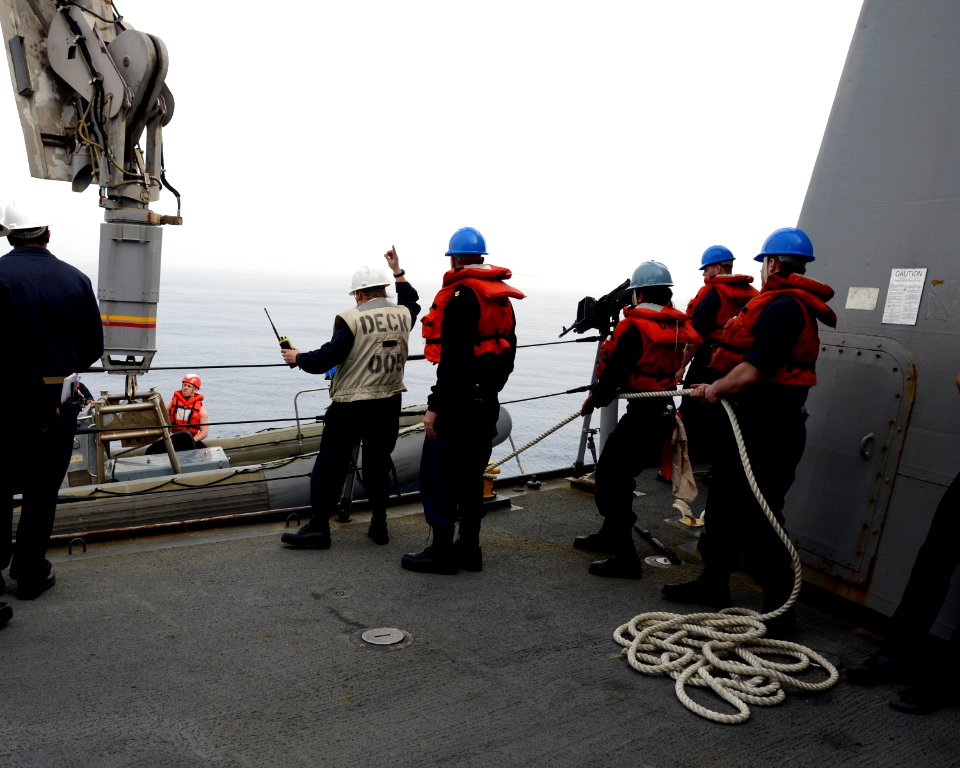 Sailors lower a rigid-hull inflatable boat into the Mediterranean Sea 140303-N-HB951-126