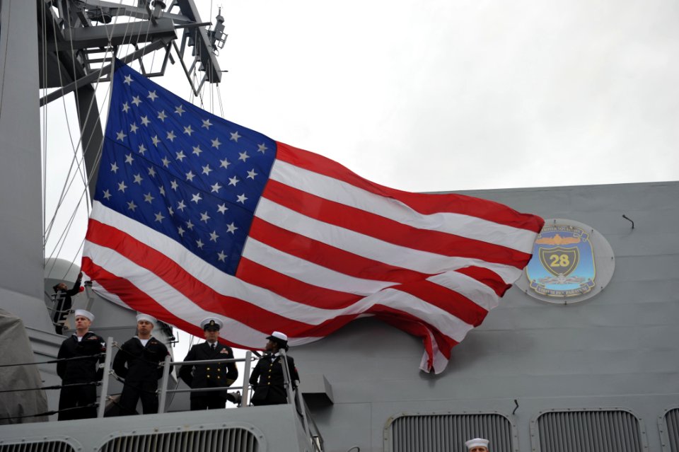 Sailors lower the American flag aboard USS Forrest Sherman. (8515023299)