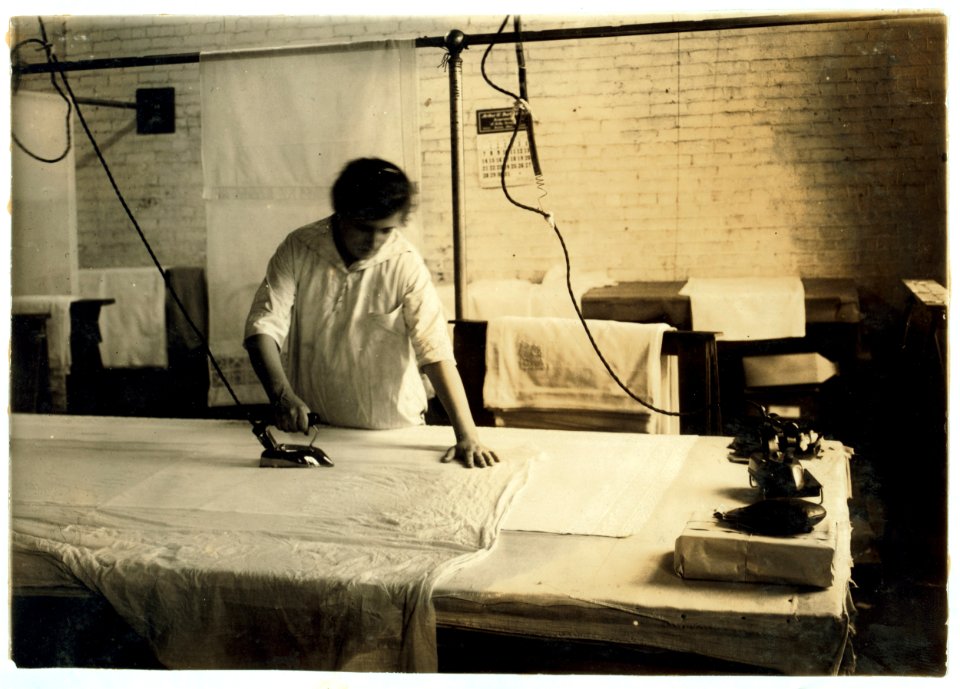 Sadie McGurin, 15 years old. Pressing curtains at Boutwell, Fairclough & Gold. 274 Summer Street Extension. Lewis W. Hine. (Mr. Fitzgerald, Manager.) LOC nclc.05190