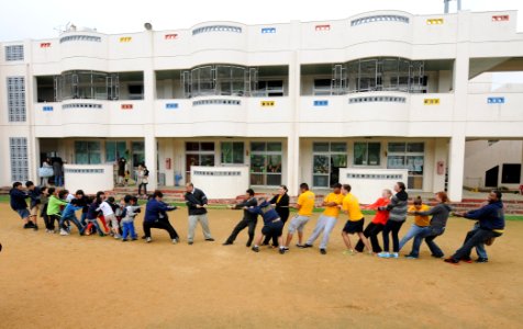 Sailors play tug-of-war with kids. (12993847925)