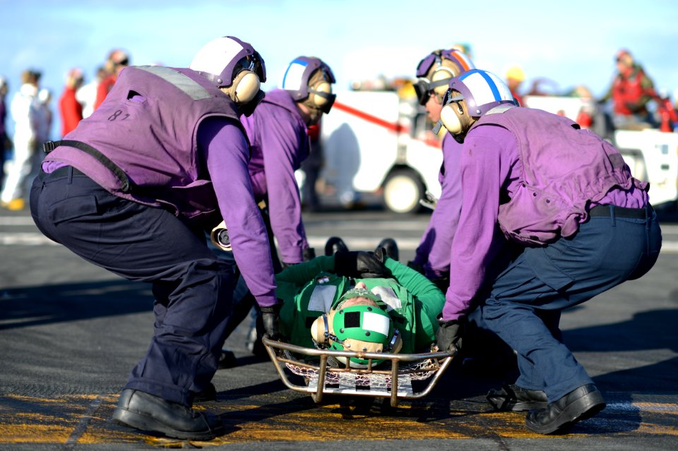 Sailors practice carrying a casualty at sea. (8435776692)