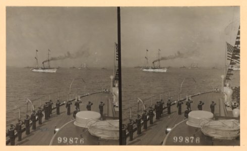Sailors on deck of ship saluting a passing ship in the distance LCCN2013650589