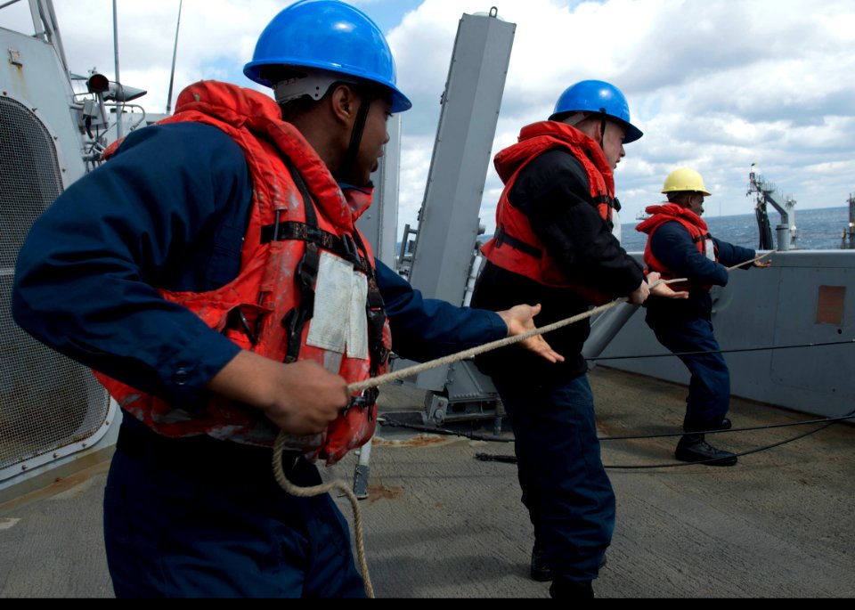 Sailors pull on a line during a replenishment-at-sea. (8591436979)