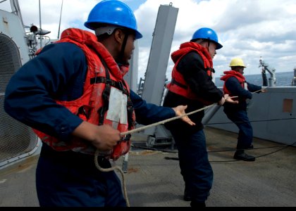Sailors pull on a line during a replenishment-at-sea. (8591436979)