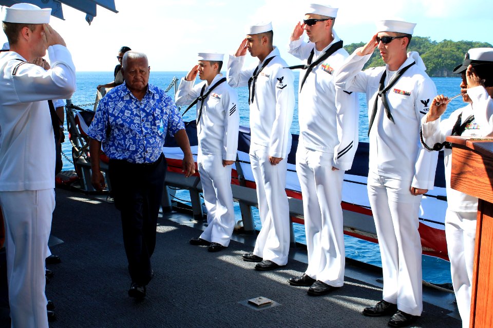 Sailors salute a guest aboard USS Higgins. (8455082967)