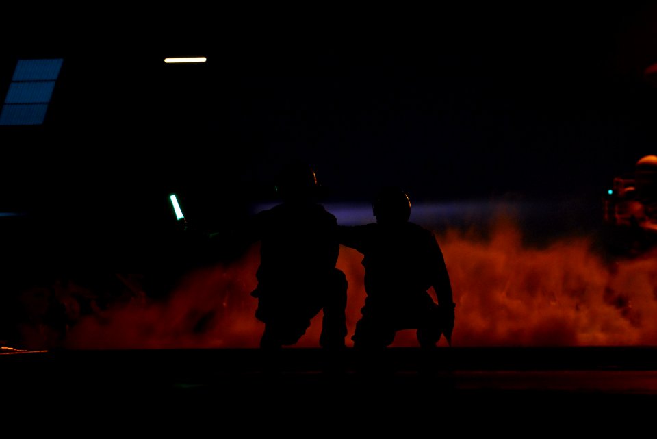 Sailors signal to launch an aircraft at night. (8468332600)