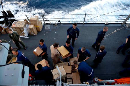 Sailors unload cargo aboard USS William P. Lawrence. (8455083327)