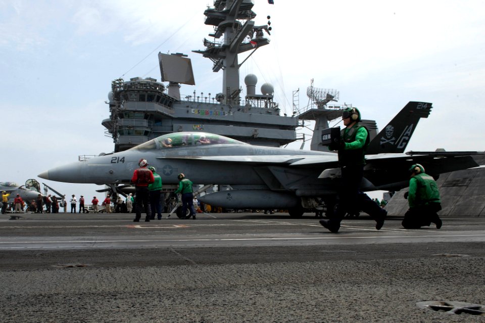 Sailors prepare to launch an F-A-18F at sea. (8579434015)