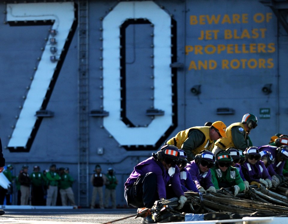 Sailors pull a barricade aboard USS Carl Vinson. (8471158610)