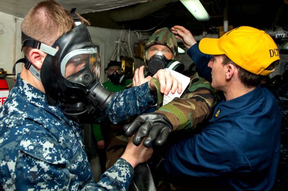 Sailors put on personal protective gear during a CBR drill. (8577550374)