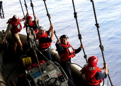 Sailor gives a thumbs up to the davit captain to inform him that the boat crew is ready to be lowered into the water (27834526544)
