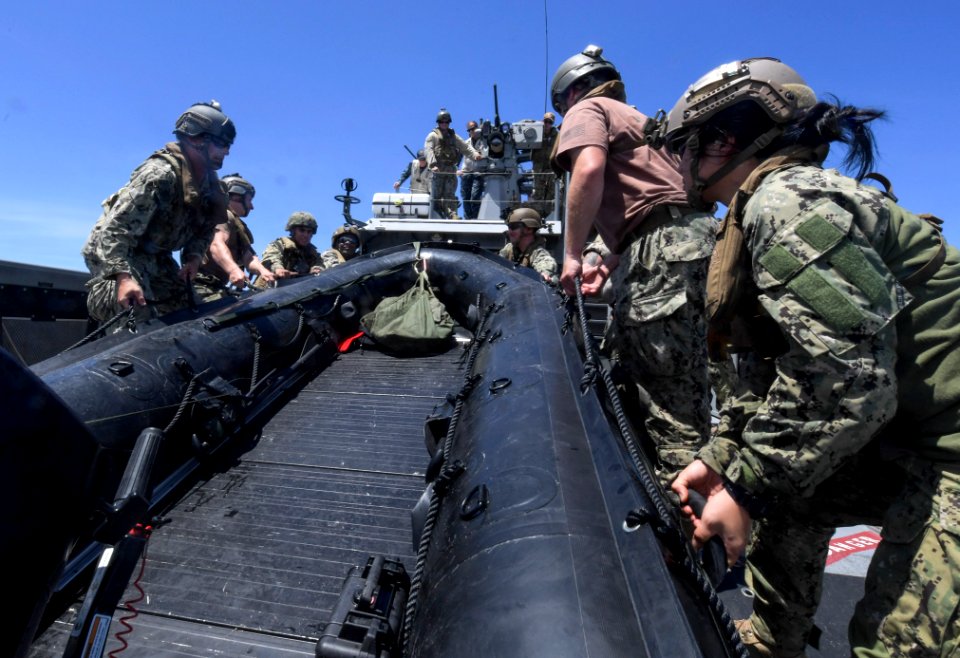 Sailors recover a combat rubber raiding craft from a patrol boat during an exercise. (26954678138)