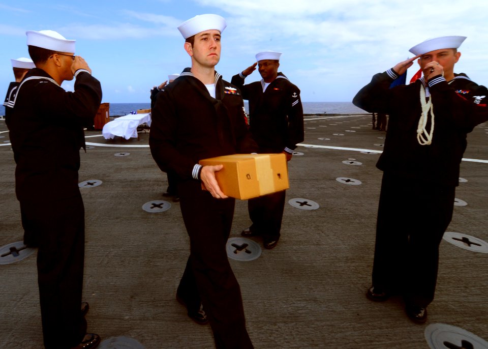Sailors salute the remains of a Navy veteran. (8573734241)