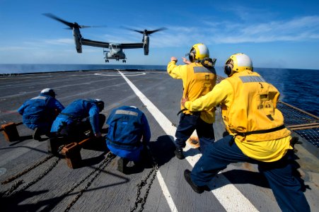 Sailors signal an MV-22 Osprey 150111-N-DQ840-121