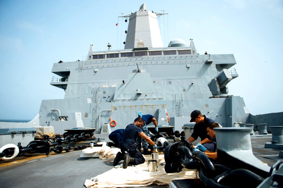 Sailors aboard USS Anchorage (LPD-23) painting the forecastle port anchor chain (150706-N-BD107-118)