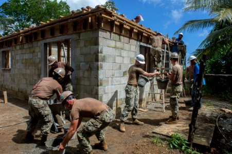 Sailors work with Kosraean workers to construct the Health Clinic in Micronesia. (34735808755)