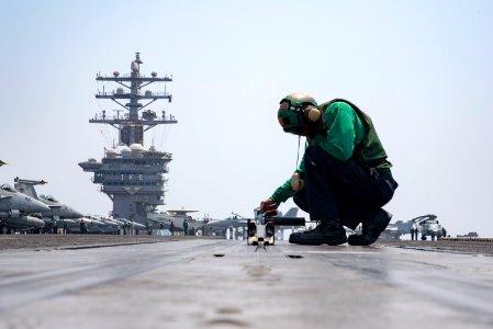 Sailor conducts maintenance on a bow catapult on the flight deck of USS Dwight D. Eisenhower. (29178272815)