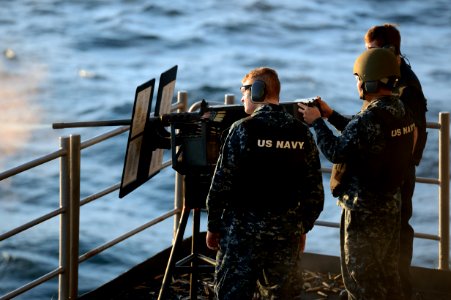 Sailor fires a .50-caliber machine gun at sea. (8382938769)
