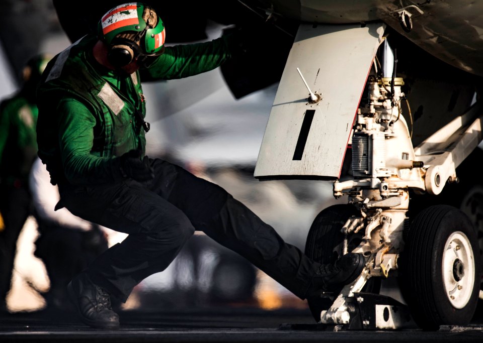 Sailor guides an E-2C Hawkeye onto the catapult. (28278530673)