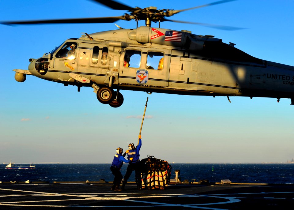 Sailors connect cargo to an MH-60S Sea Hawk helicopter. (16793243051)