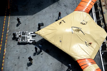 Sailor moves an X-47B from an aircraft elevator aboard USS George H.W. Bush. (8721191302)