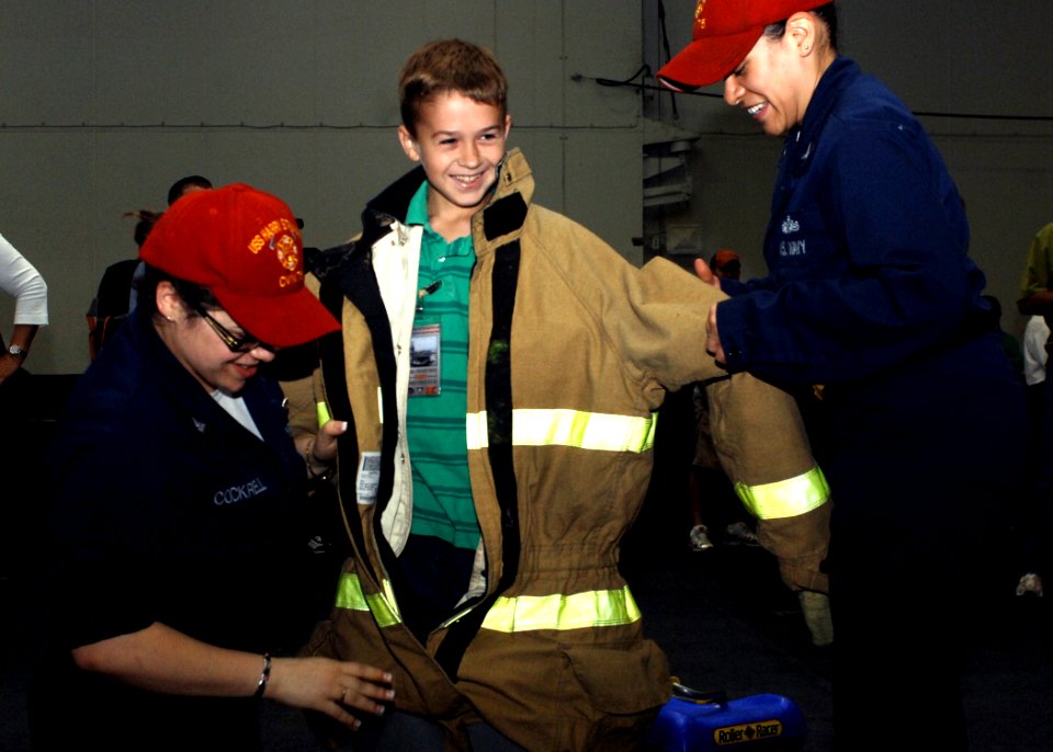 Sailors don child in firefighting gear during Tiger Cruise 2008 DVIDS96022
