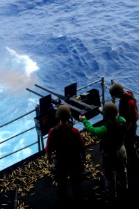 Sailors fire a machine gun at sea. (8594721965)