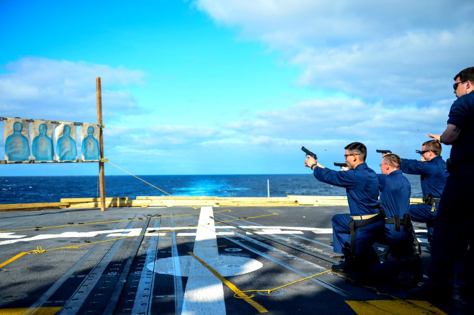 Sailors fire M9 pistols. (8652158421)