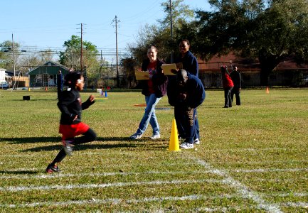 Sailors help children at an athletics event. (8599729183)