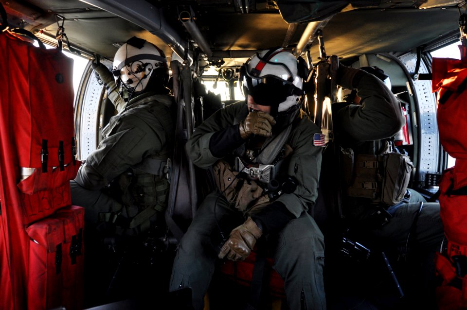 Sailors inside an MH-60S Sea Hawk. (8229184131)