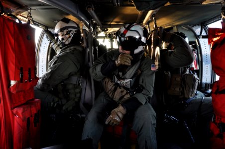 Sailors inside an MH-60S Sea Hawk. (8229184131)
