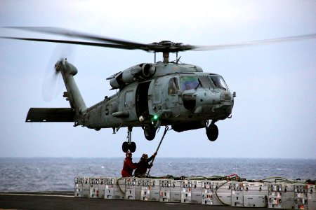 Sailors attach ammunition to an MH-60S. (8202185079)