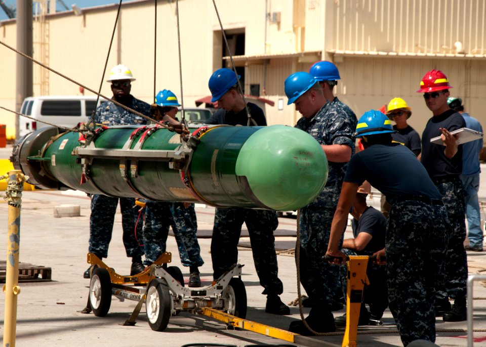 Sailors lower a torpedo to the pier. (8200233030)