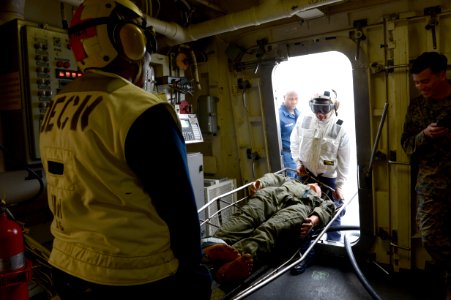 Sailors carry a stretcher during a drill at sea. (8488250151)