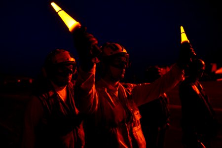 Sailors direct aircraft at night. (8468332534)