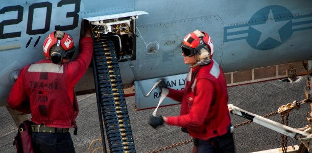 Sailors download rounds from an F-A-18E Super Hornet aboard USS Carl Vinson 141028-N-TP834-530