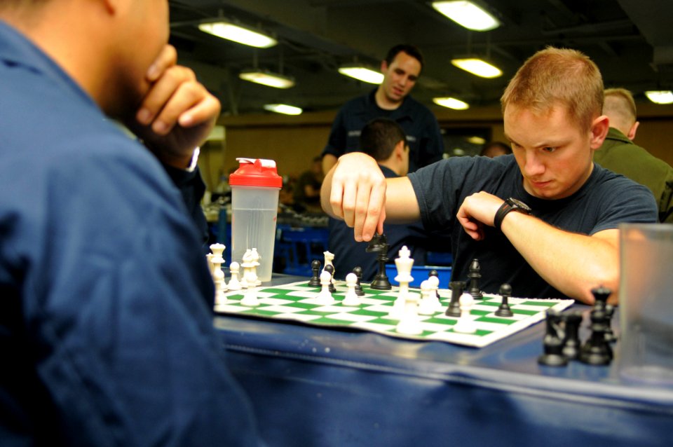 Sailors play in a chess tournament at sea