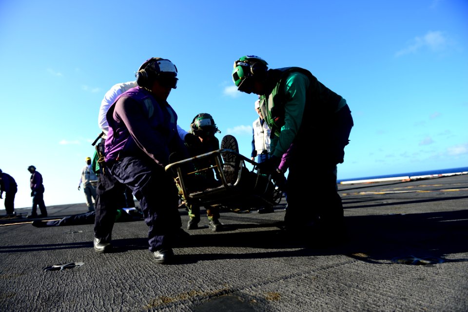 Sailors practice carrying a casualty at sea. (8435775738)
