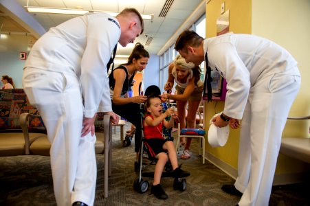 Sailors give out a Navy ball cap and stickers to a child in Cardinal Glennon - Children’s Hospital in St. Louis, Mo. (26365022743)