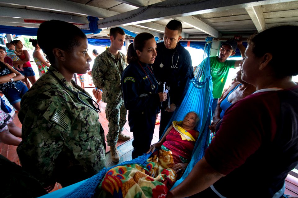 Sailors help elderly woman on the Amazon River. (37816004445)
