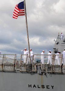 Sailors raise the American flag aboard USS Halsey. (8489345428)